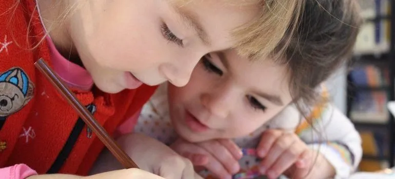 moving to Closter with your family - kids looking and writing