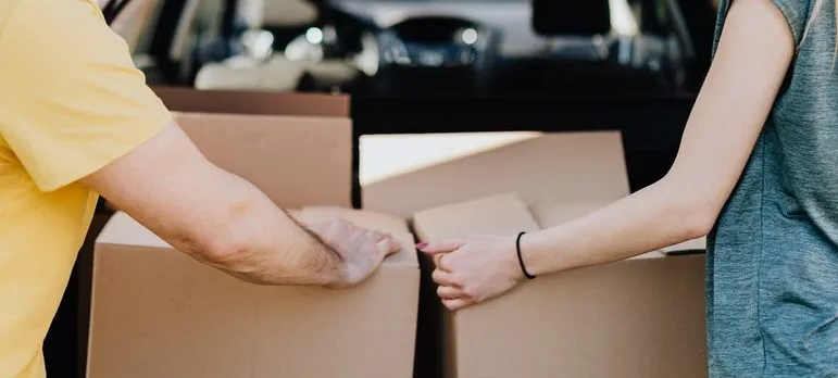 A couple loading car with moving boxes