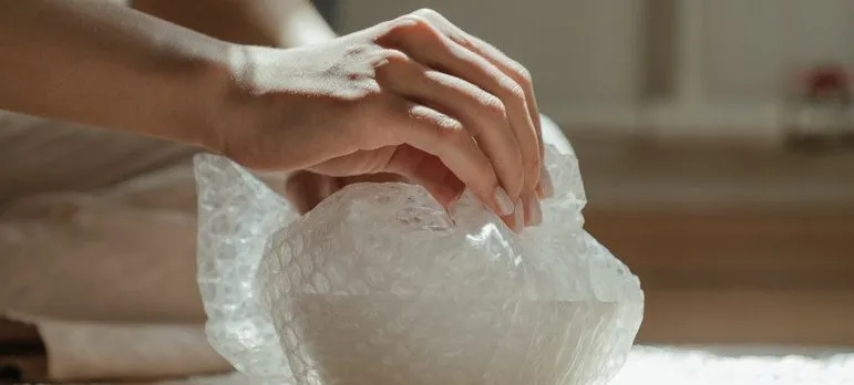 A woman packing pottery