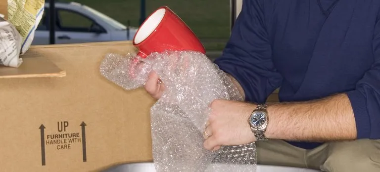 Man unpacking moving box