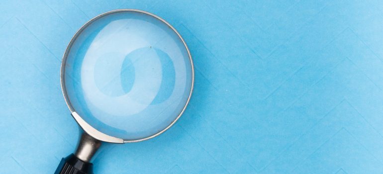 A magnifying glass on a blue surface