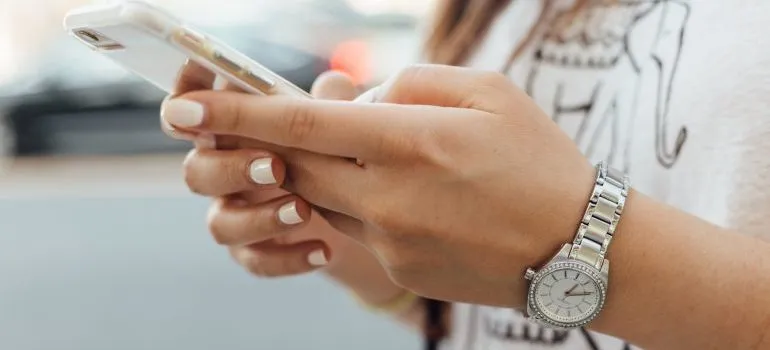 A woman texting, a way to deal with moving away from parents