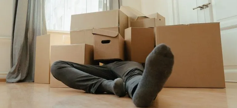 A man covered with boxes