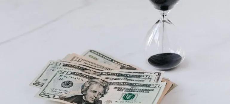 An hourglass and money