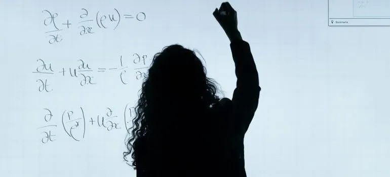 Teacher writing on a whiteboard