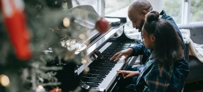 Father playing the piano with her daughter