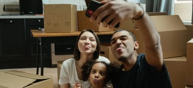 Family taking a photo after packing
