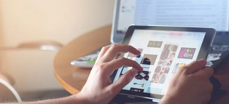 a person using 2 devices simultaneously to browse the internet