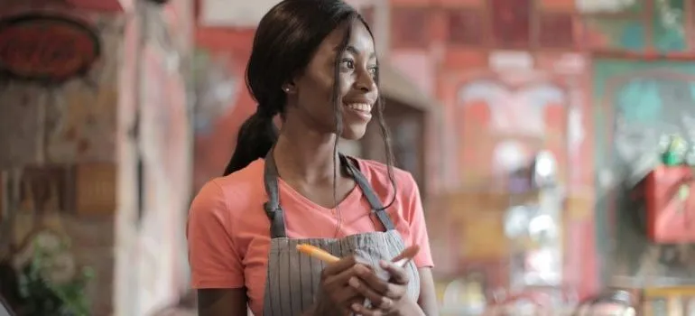 a smiling waitress taking order