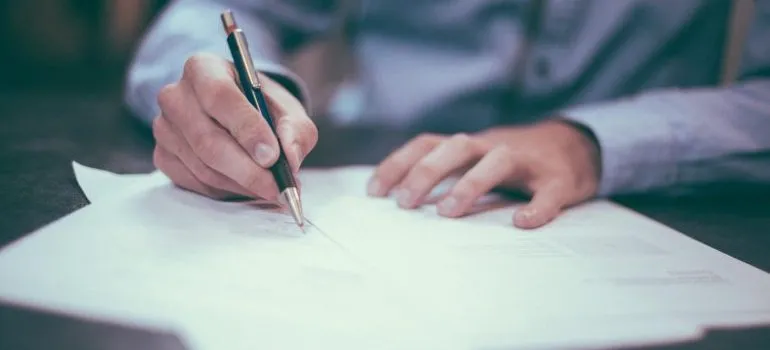 man signing papers 