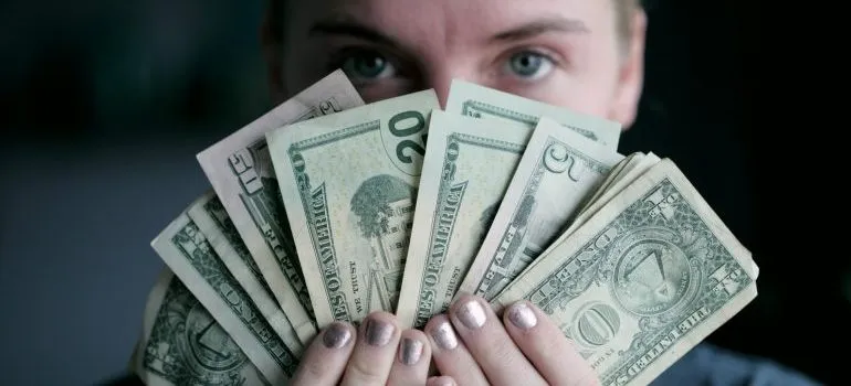 Woman holding dollar bills