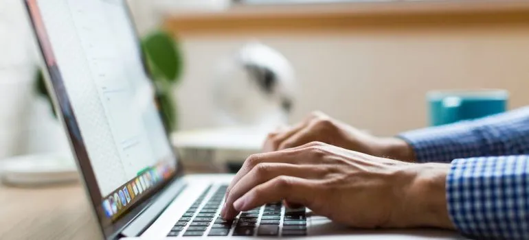 a person typing on its laptop