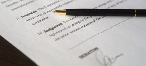a picture of a contract and a black pen on top of it
