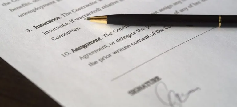 a picture of a contract and a black pen on top of it