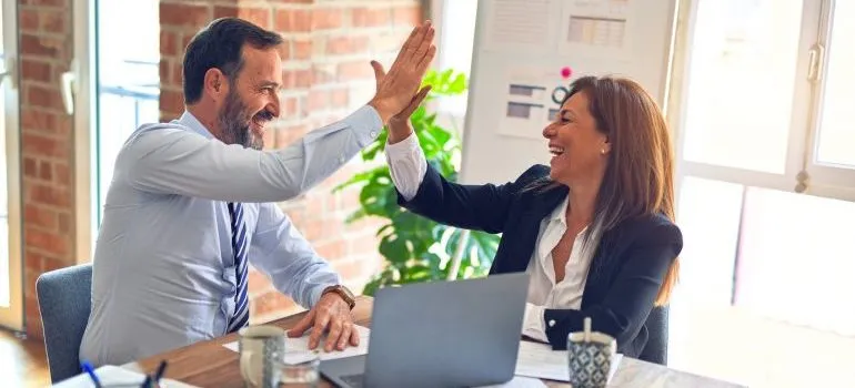man and woman clapping hands 