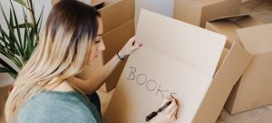 woman writing a on a box