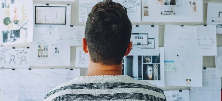 A man looking at a plan on how to downsize when moving.