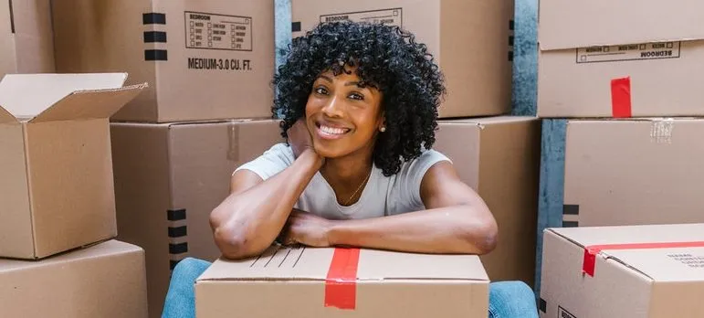 A woman and cardboard boxes