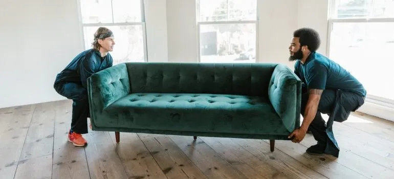 Movers carrying a couch.