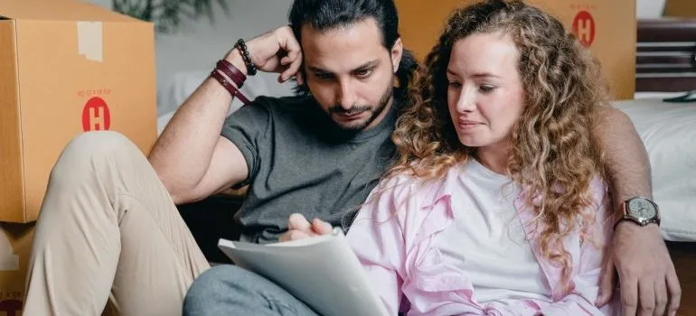 Couple going through a moving checklist.