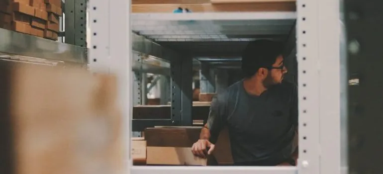 Man under a bunch of large shelves