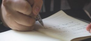 a person writing on a paper