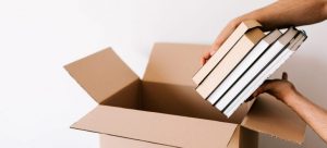 Packing books in a cardboard box
