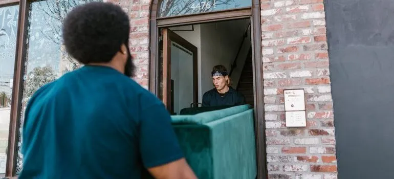 Movers carry furniture