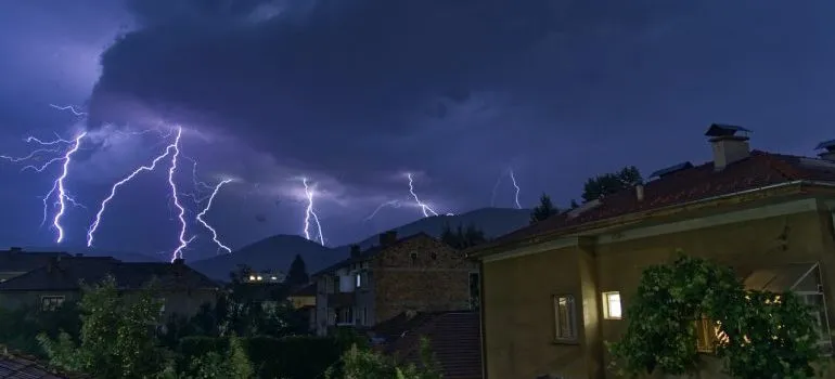 Yellow and brown house with thunder in the background