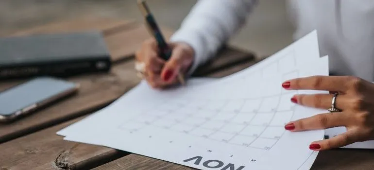 Woman filling calendar by months.