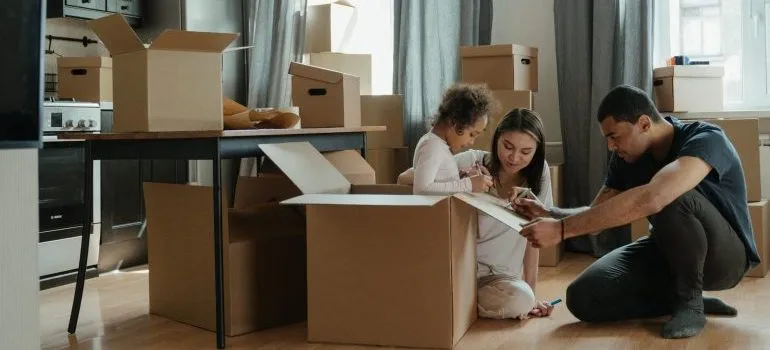 Family packing boxes for moving to New Jersey during holidays