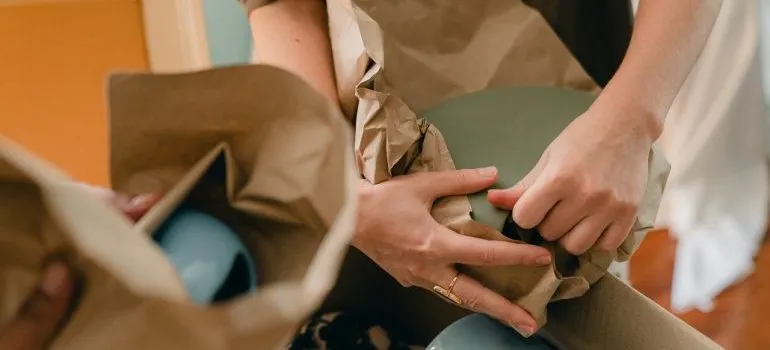 A person packing for the relocation to Brooklyn during holidays