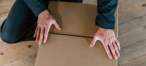 A person packing a moving box
