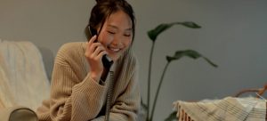A woman on the phone booking moving services in advance