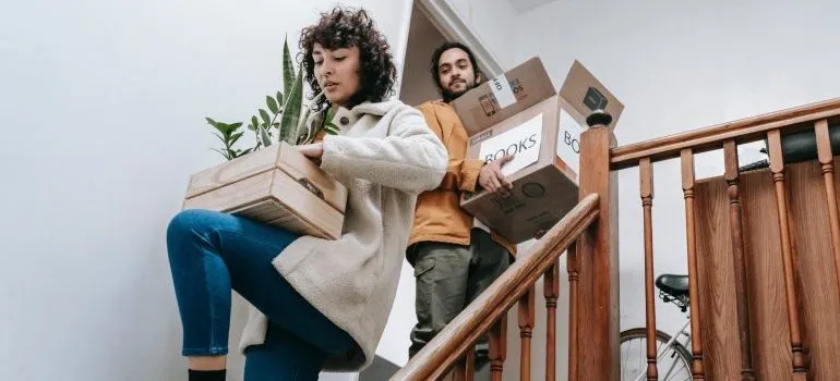 A couple carrying boxes