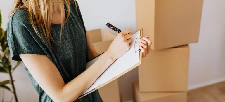 A woman writing in the notebook