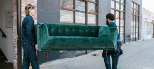 Movers carry a sofa
